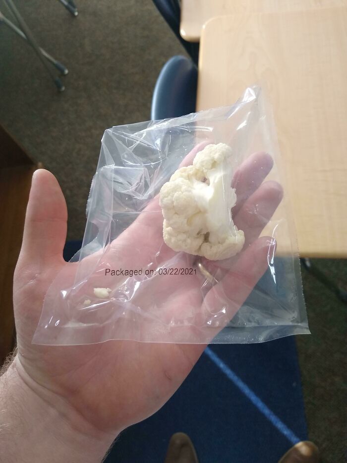 A Single Cauliflower In A Single Use Plastic Wrap From A School Lunch