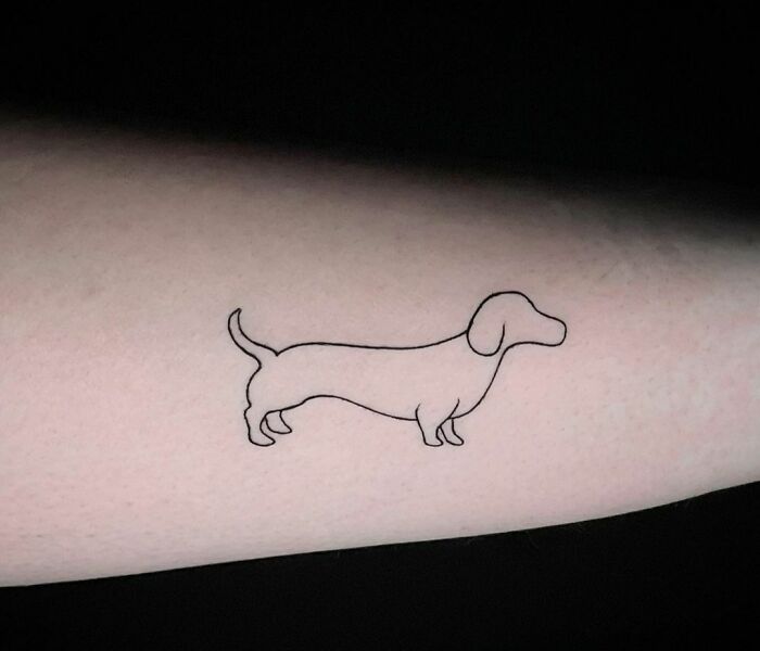 minimalistic tattoo of a dachschund dog