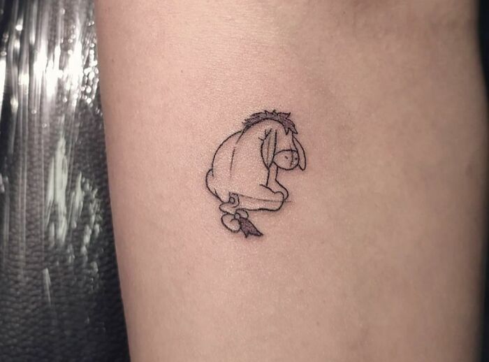 minimalistic tattoo of eeyore donkey from winnie the pooh