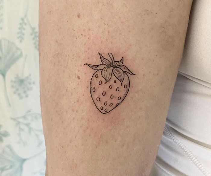minimalistic tattoo of a strawberry