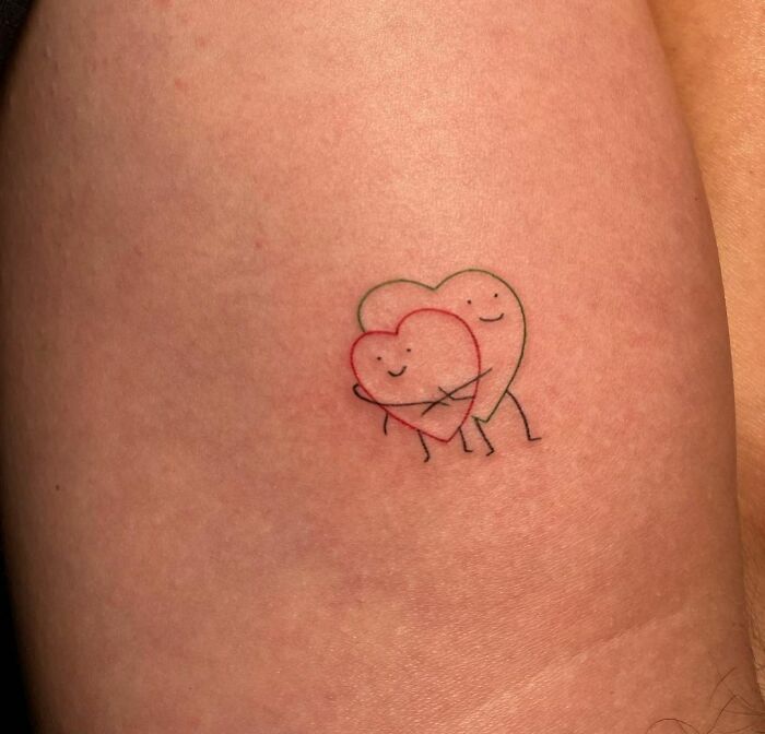 minimalistic tattoo of two hearts hugging
