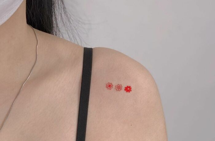 Minimalistic red flowers tattoo