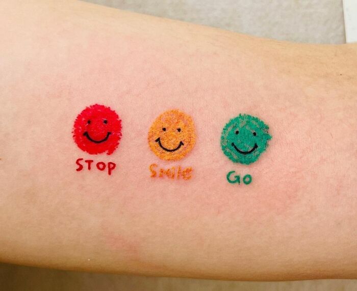 Minimalistic smiley traffic lights tattoo