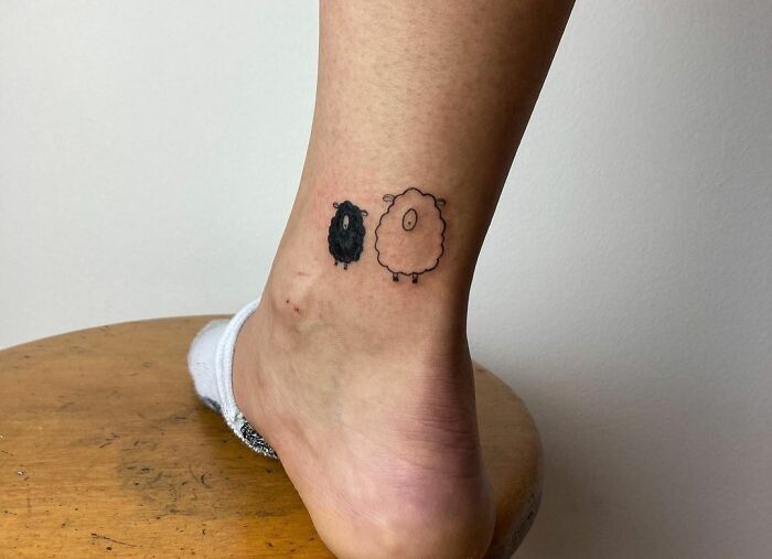 Minimalistic black and white sheeps ankle tattoo