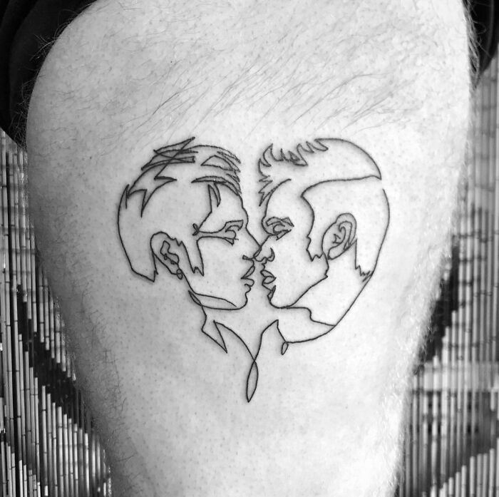 Single line tattoo of two people kissing each other