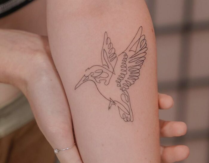 Single line flying bird tattoo