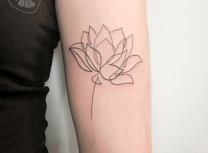Single line flower tricep tattoo