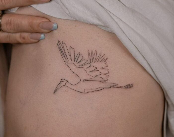 Single line flying stork tattoo