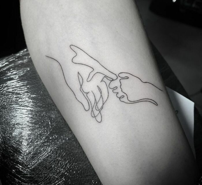 Single line taking hands together tattoo