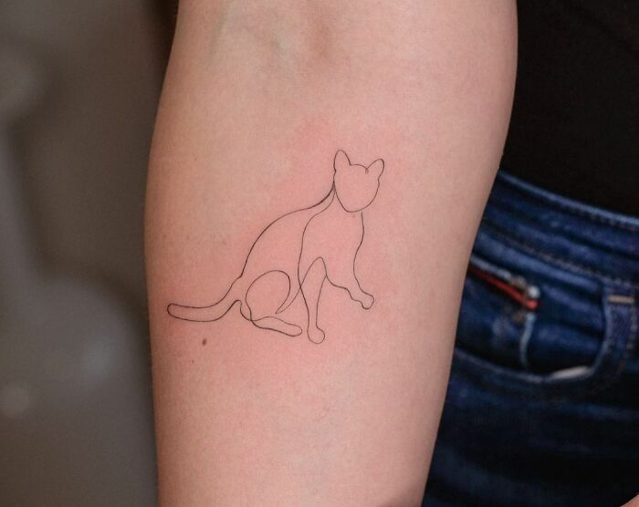 Single line cat raising leg elbow tattoo