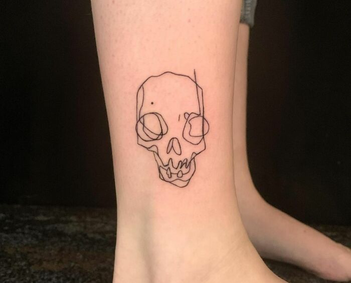 Single line skull ankle tattoo