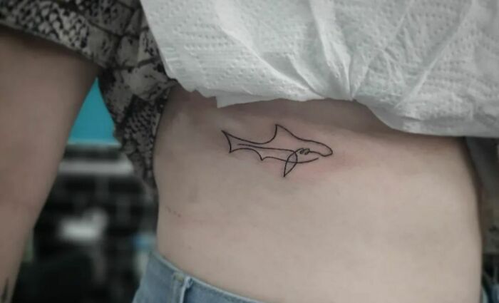 Minimalistic single line shark tattoo