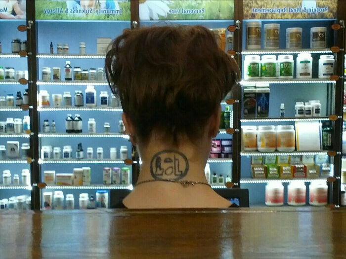 Funny neck tattoo with "LOL" text in a pharmacy setting.