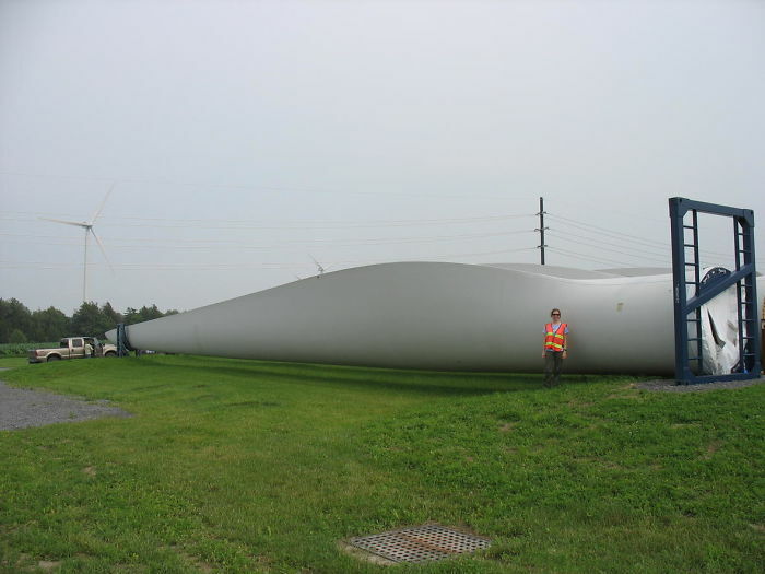 Human Next To Wind Turbine Blade