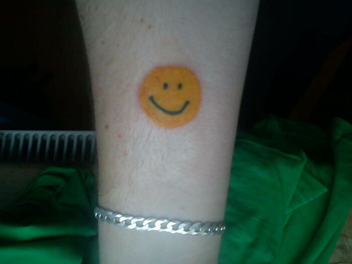 Colorful Smiley Face Hand Tattoo