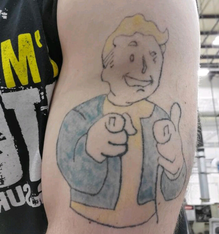 Poorly designed colorful person arm tattoo 