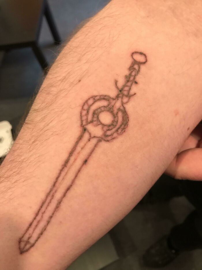Poorly designed sword arm tattoo 
