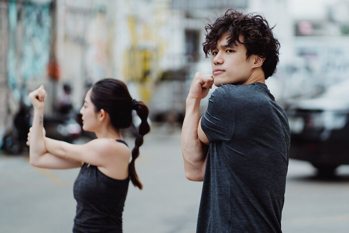 Woman and man stretching on the street 