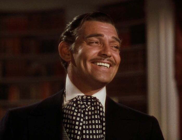 Clark Gable smiling wearing black jacket in "Gone With The Wind" movie 