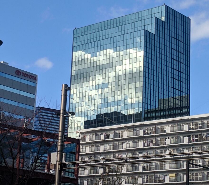 The Reflection Of A Cloud On This Building Looks Like Pixel Art