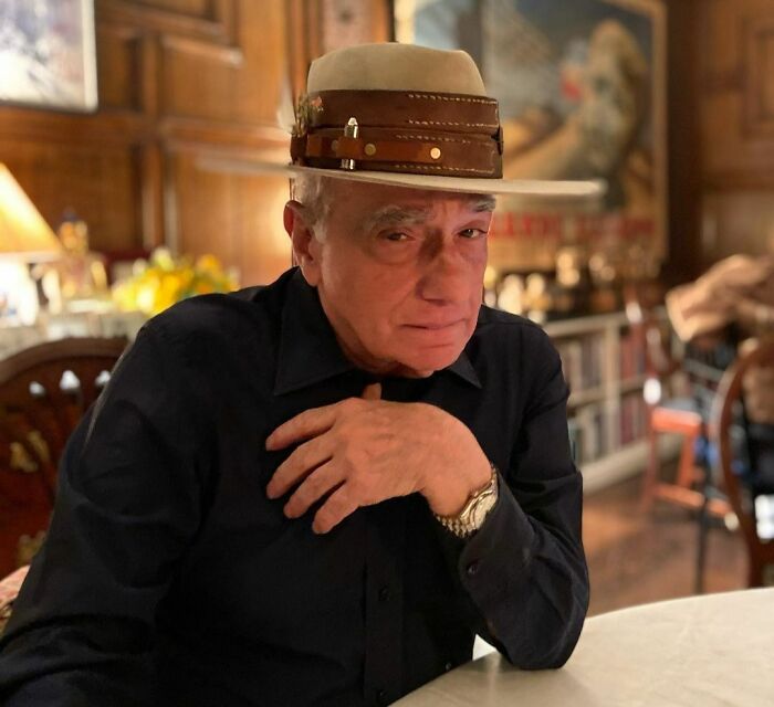 Martin Scorsese wearing beige hat and black shirt 