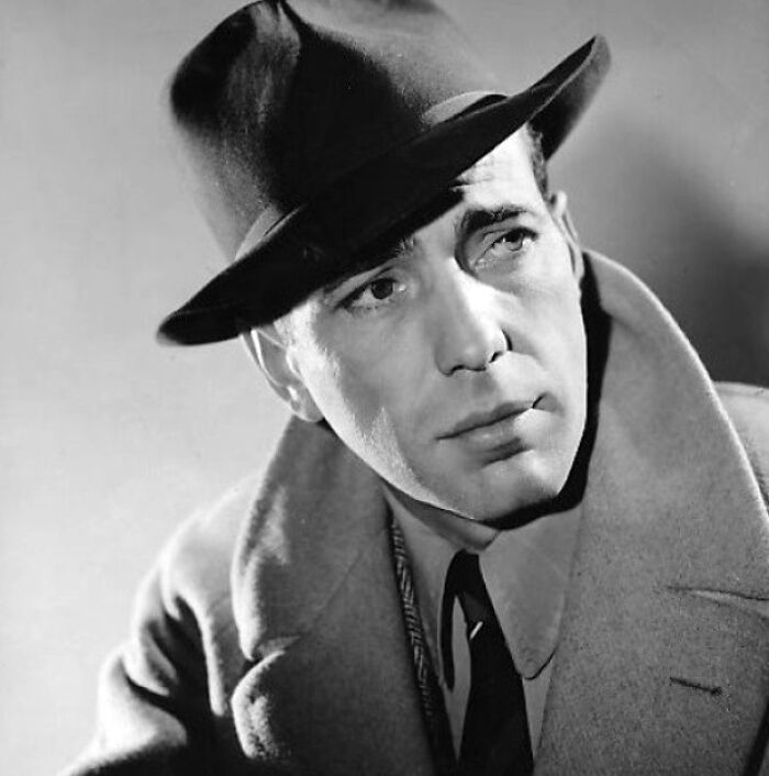 Humphrey Bogart wearing black hat and a cot 
