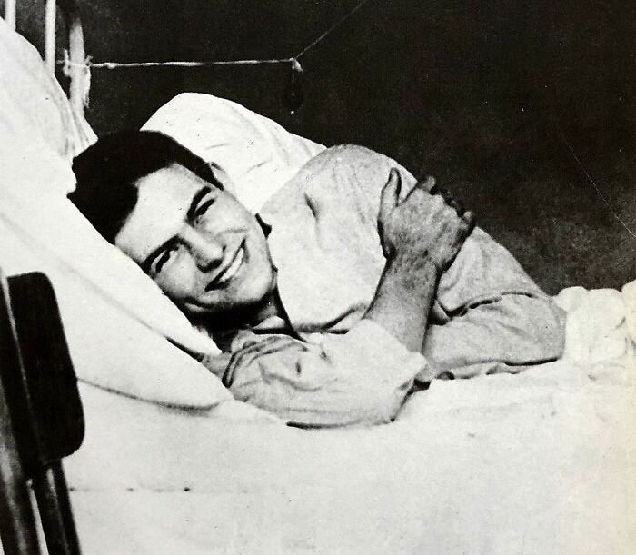 Ernest Hemingway lying on the bed 