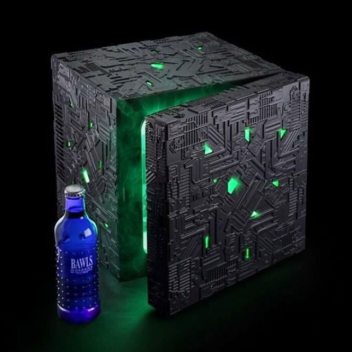 Star Trek Borg Cube Fridge with a blue glass bottle near 
