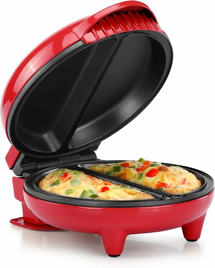 Red and black omelet maker pan with omelet inside 