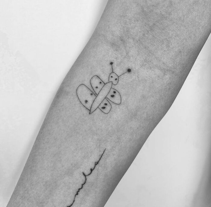 Simple butterfly tattoo on forearm, showcasing unique celebrity tattoos.