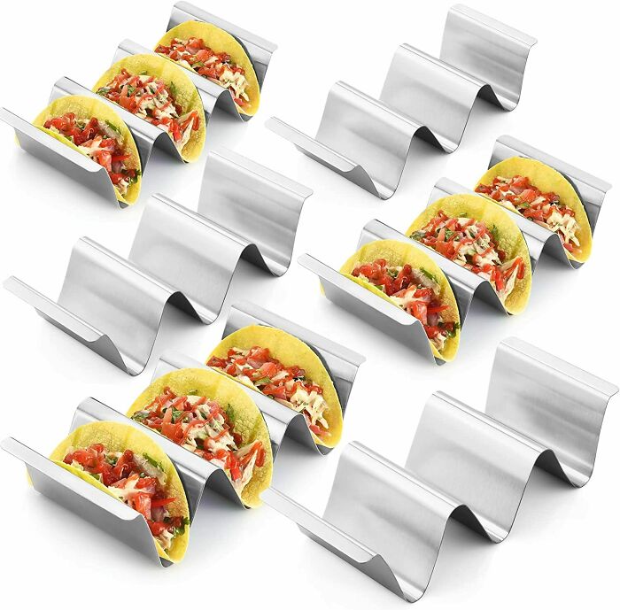 Multiple steel taco holders with tacos inside 