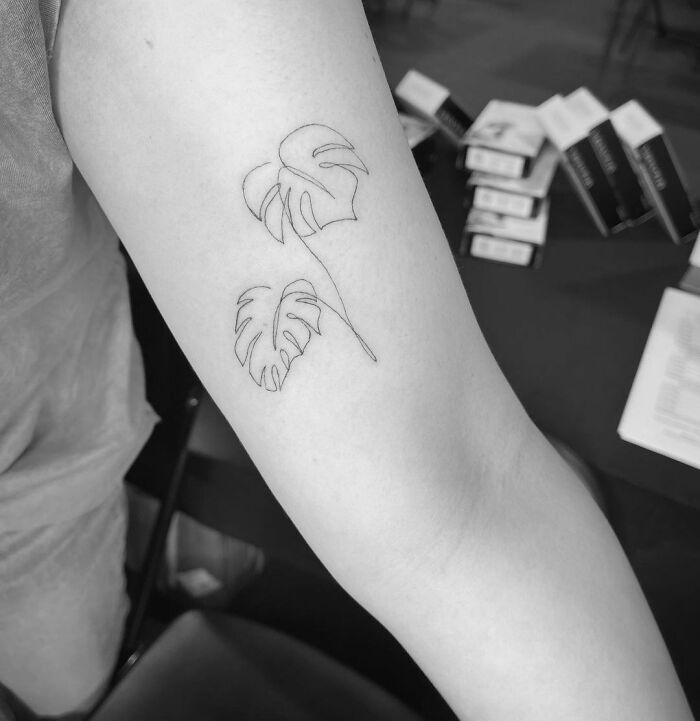Single line leaves arm tattoo