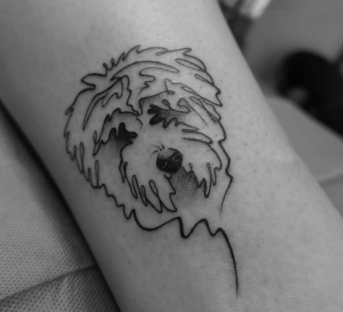 Single line dog portrait arm tattoo