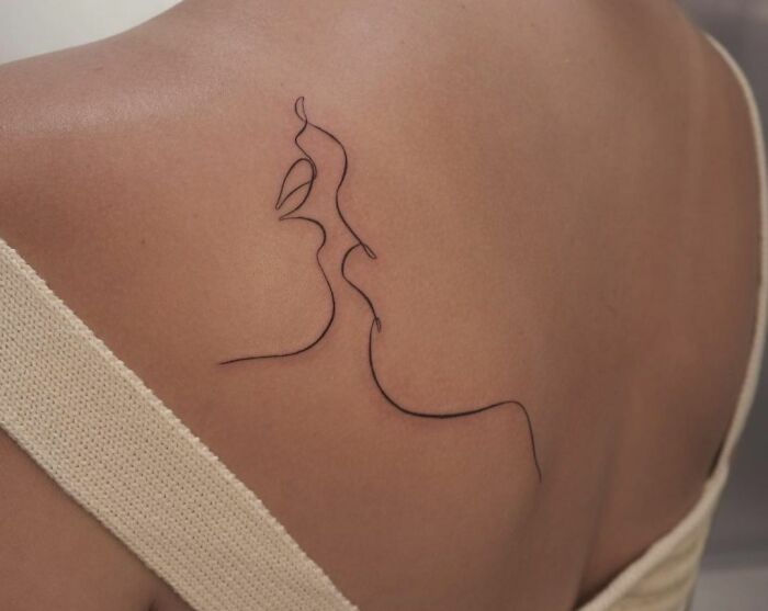 Single line kiss back tattoo