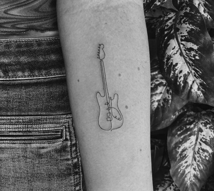 Line guitar arm tattoo