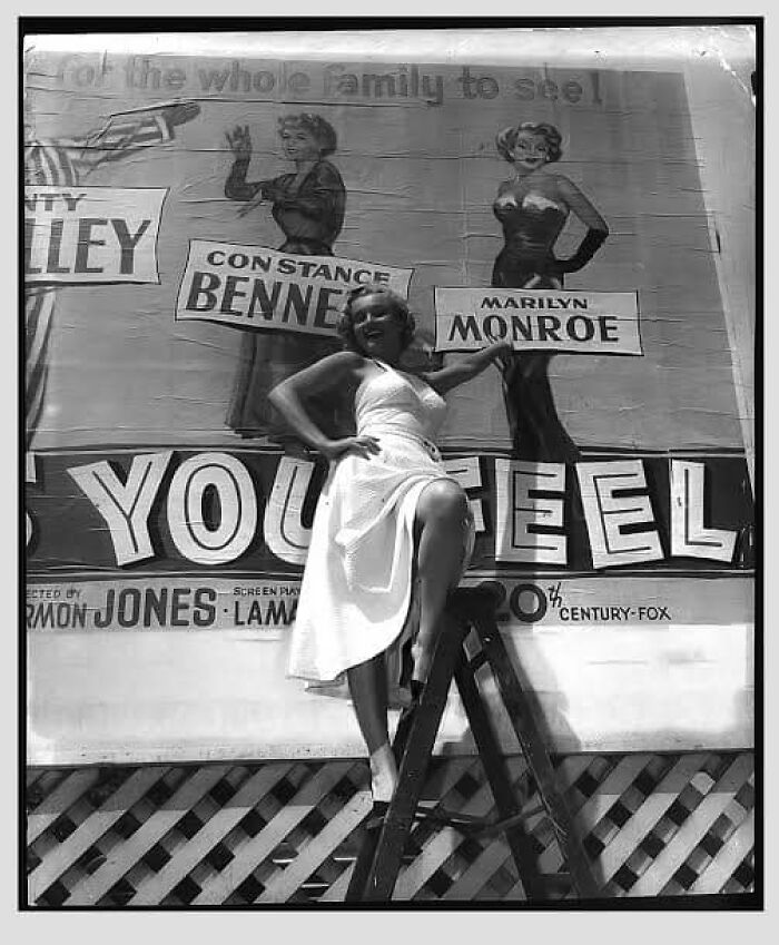 Marilyn Monroe In Front Of A Billboard For As Young As You Feel, 20th Century Fox, 1951