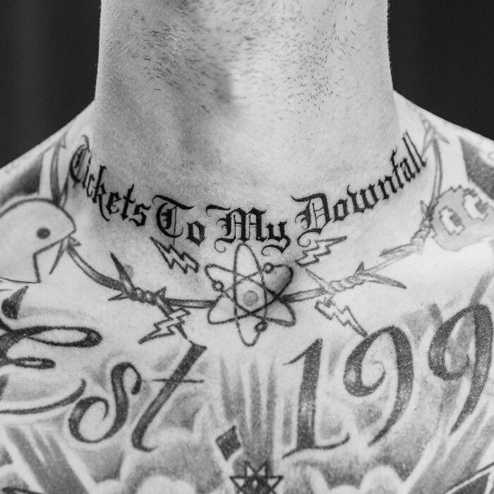Neck and chest tattoo featuring "Tickets To My Downfall" with intricate designs. Celebrity tattoos.