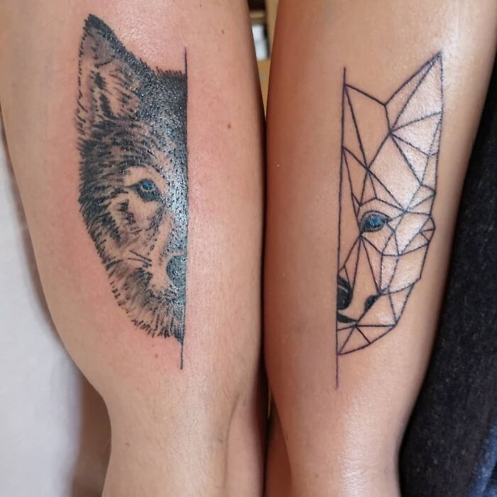Wolf faces on of them in illuminati style tricep tattoos