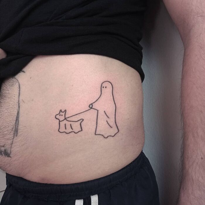 Funny tattoo of a ghost walking a dog, drawn simply on someone's side.