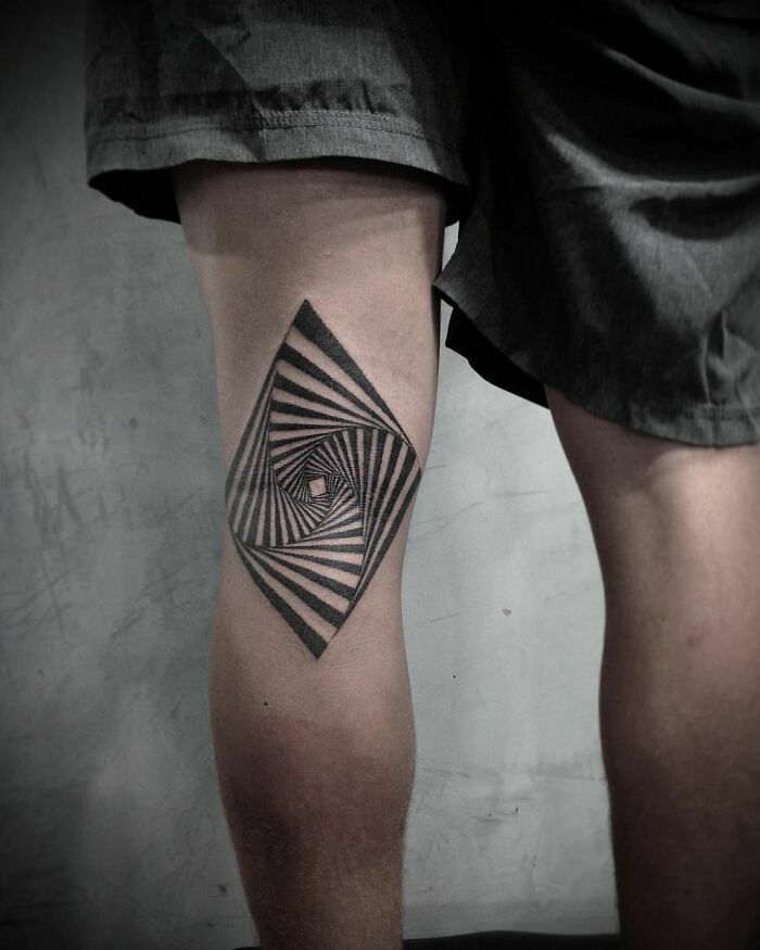 Optical illusion tattoo on a person's leg, featuring a spiral design that tricks the eyes.