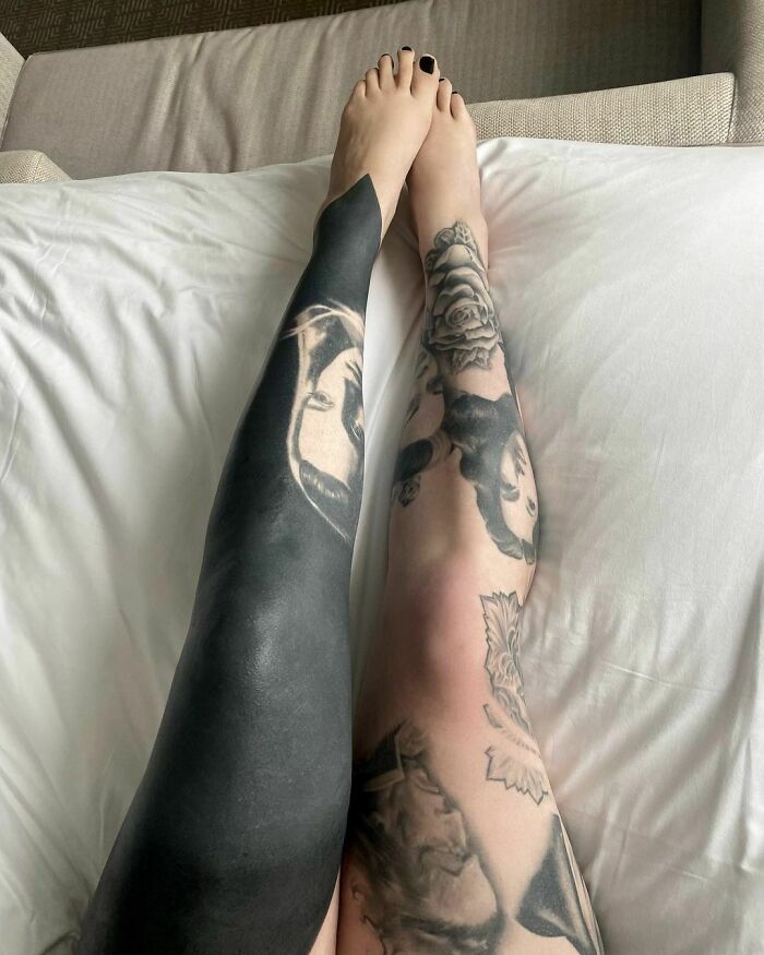 Two legs covered in celebrity tattoos, one leg fully blacked out, featuring detailed portrait designs.