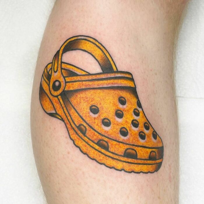 Yellow Crocs arm tattoo 