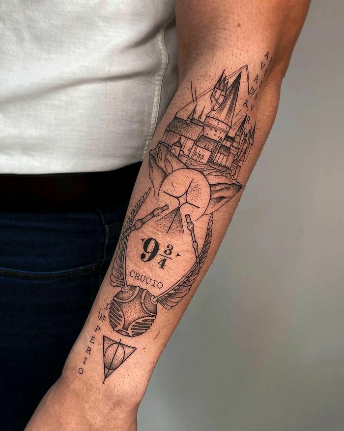 Harry Potter tattoo featuring Hogwarts, Platform 9 3/4, and the Deathly Hallows on an arm.