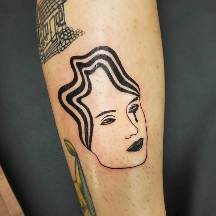 minimalistic tattoo of a woman's face