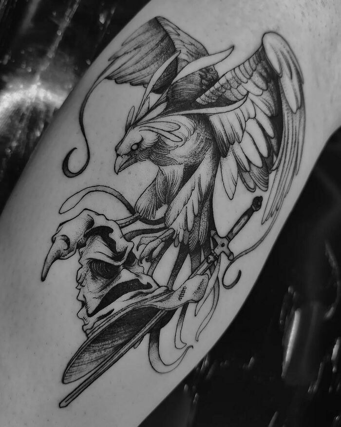Black and white Harry Potter tattoo featuring a mythical bird and a sword intertwined with a skull and hat.