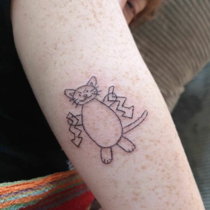 Simple cat tattoo design on forearm, showcasing a funny and cute style.