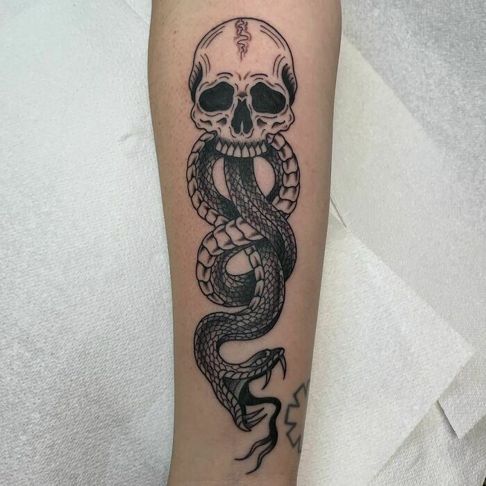Dark Mark tattoo featuring a skull and serpent, a popular design for Harry Potter fans.