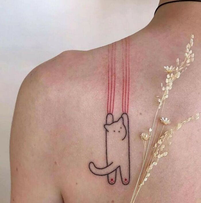 Colorful cat and red tear spots back tattoo 