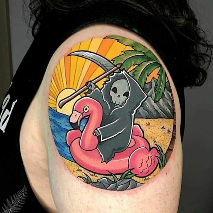 Humorous tattoo of Grim Reaper riding a flamingo floatie, set against a tropical beach background.