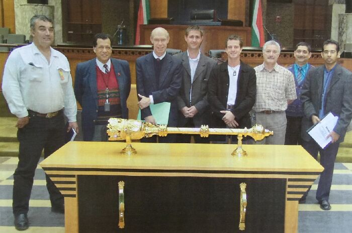 Designer Grant Schreiber (center) reviews the old Parliamentary Mace with a team from the South African Parliament, in preparation for the design of the new mace, 2004